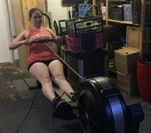 Fundraiser Mel rowing on her rowing machine
