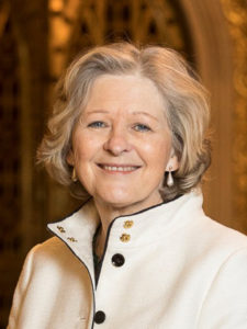 A photo of Professor Shiela the Baroness Hollins. She is a white woman with fair hair, wearing a white jacket.