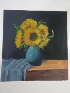 Painting of sunflowers in a vase, on top of a table