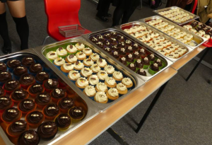 Chocolate and vanilla cupcakes in rows displayed on a table