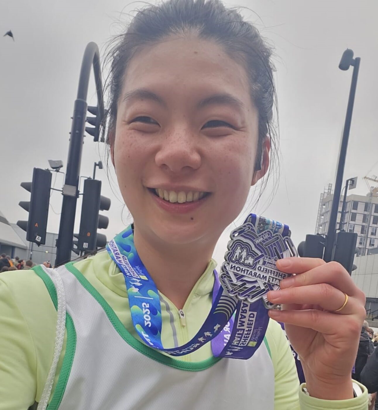 Sharon, smiling and holding a medal