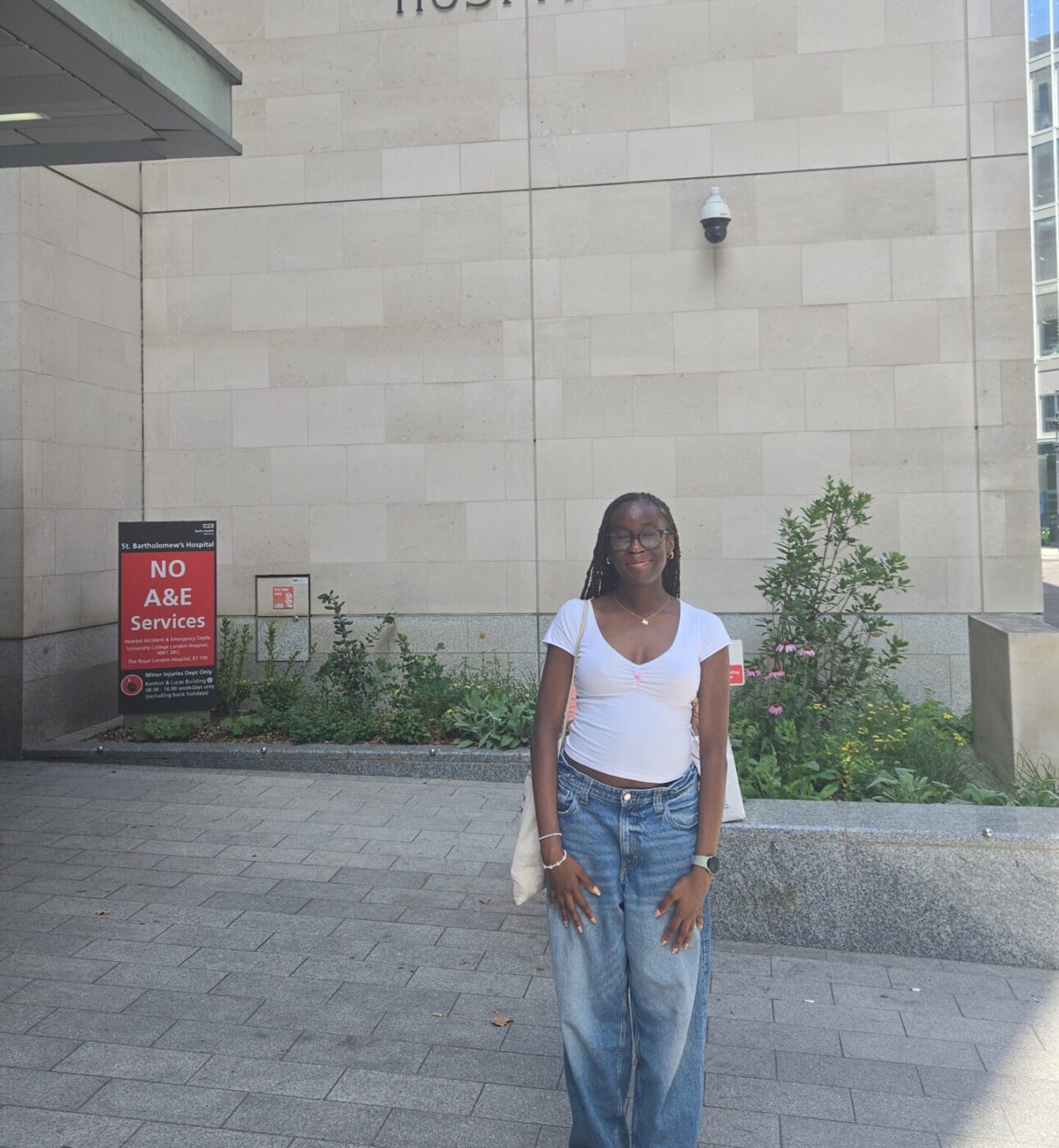 Michelle, smiling and standing in front of St Bartholomew's Hospital